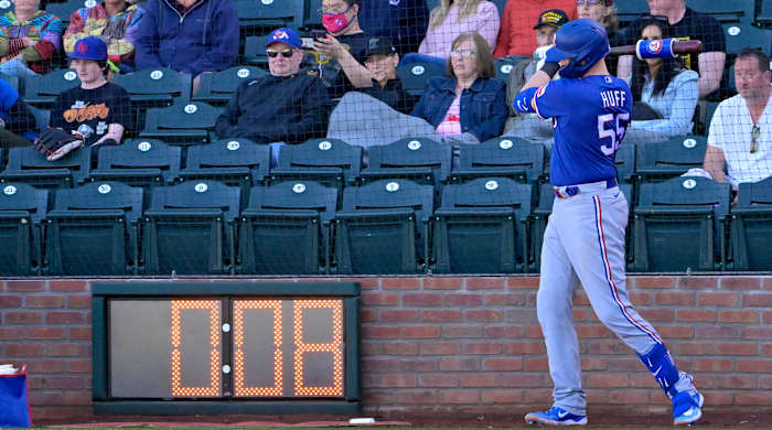 Rangers catcher Sam Huff waits in the batting circle as the pitch timer winds down in the background